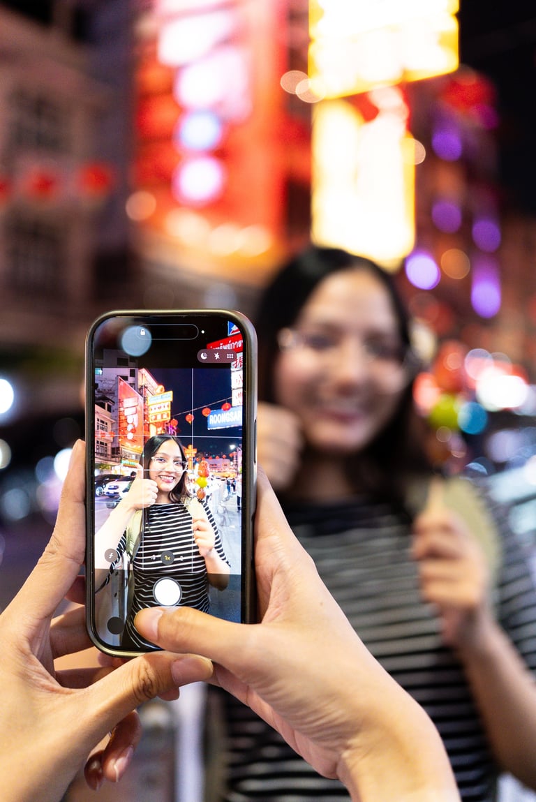 Happy beautiful woman influencer with colorful neon-lit night market backdrop, creating social media content
